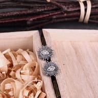 Close-up detail of the radiant beams and center stone accent on the eye earring