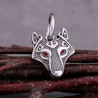 Stainless steel Viking wolf earrings displayed on a dark surface to highlight metalwork details
