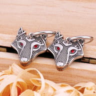 Profile view of the stainless steel wolf drop earring highlighting the hinged huggie hoop clasp