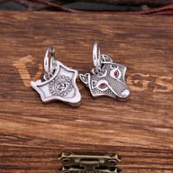 Pair of stainless steel Viking wolf drop earrings showing the front wolf head with red eyes and the reverse side with Celtic runes