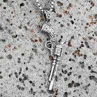 Close-up of the ornate handle and top of the revolver pendant with chain