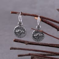 Close-up of the men's stainless steel dangle earring featuring a detailed Vegvisir compass charm.