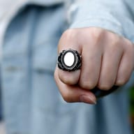 Side view of the 316L stainless steel punk ring, showcasing the prominent skull motif and intricate scrolled patterns.