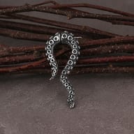 Stainless steel octopus tentacle earrings shown worn on an earlobe