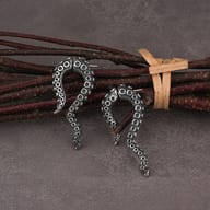 Side profile of curved octopus tentacle drop earrings showing post placement