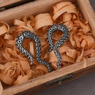 Close up view of textured suction cups on stainless steel tentacle earrings