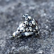 Detailed view of the red zircon gemstone and its intricate bezel setting on the skull ring.