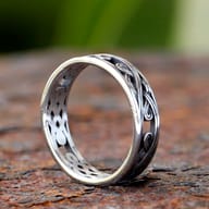 Stainless steel ring with Nordic-inspired Celtic knot pattern, angled view.