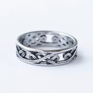 Angled view of a men's durable stainless steel Celtic knot ring.