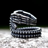 Side profile of the Alien Creature ring, showcasing the textured stainless steel band