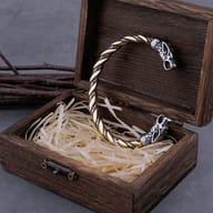 Two-tone stainless steel Viking dragon head cuff bracelet displayed in an open rustic wooden gift box