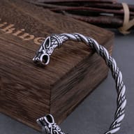 Close-up of the sculpted dragon head terminal on the two-tone Viking torque bracelet