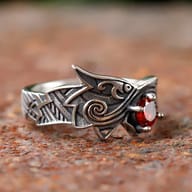Angled view of the ring's band and dragon head, highlighting texture and material