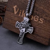 Stainless steel Jesus cross pendant and chain, showcasing the sturdy link design, partially in a wooden box.