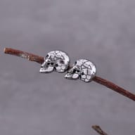 Side angle view of stainless steel gothic skull stud earring