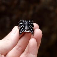 Detailed view of the spider's textured abdomen and legs on a gothic-inspired stainless steel ring.