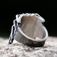 Side angle close-up of the stereoscopic spider design on a men's stainless steel ring.