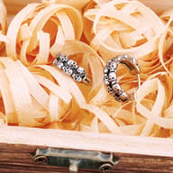 View showing the oxidized finish and textured skulls of the earrings