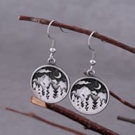 Close-up of the earring hook and top bead of a single stainless steel mountain forest moon earring.