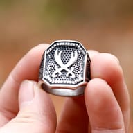 Angled view of the Ali Zulfikar sword ring, showing the robust 316L stainless steel construction and the patterned sides of the band.