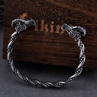 Viking goat head stainless steel twisted cuff bracelet resting against a wooden box
