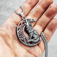 Close-up of 316L stainless steel wolf howling at moon pendant design