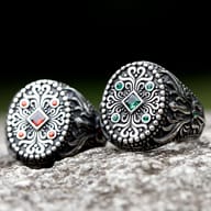 Overhead shot of the men's vintage-style ring, showcasing the square green stone and beaded details.