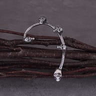 Front view of the curved gothic skull ear cuff earring pair