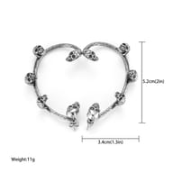 Detailed shot of skull ear cuffs showcasing fit and textured metal accents