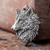 Detailed 316L stainless steel Viking wolf head pendant resting on a rustic wooden background