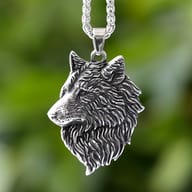 Close-up of the textured wolf head pendant highlighting the antiqued steel finish