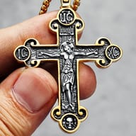 Lower part of the Jesus cross necklace, featuring small skull engravings at the base.