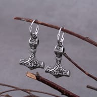 Pair of stainless steel Viking Thor's hammer dangle hoop earrings hanging on a branch