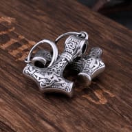Back view of Mjolnir dangle earrings displaying smooth metal finish and clasp