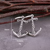 Side profile view showing the secure hoop closure and anchor charm connection