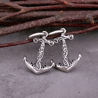 Pair of vintage Viking anchor dangle earrings resting flat on a neutral background