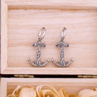 Front view of anchor drop earrings showing the polished huggie hoop clasp