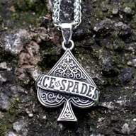 Close-up of Ace of Spades stainless steel pendant necklace on a mossy rock