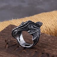 Top-down view of the intricately sculpted stainless steel dragon ring with a dark finish