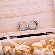 Front view displaying the oxidized engraved motifs on the men's hoop earrings