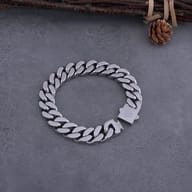 Viking Valknut Cuban link bracelet resting on rustic wooden display
