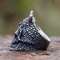Upper-left detail of the horned cyclops skull ring, highlighting the detailed texture and a single horn.