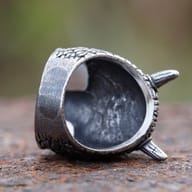 Detailed view of the horned cyclops skull ring, focusing on the rough-textured surface and the skull's features.