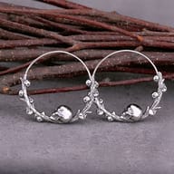 Side profile view highlighting the carved skull details and hoop curve