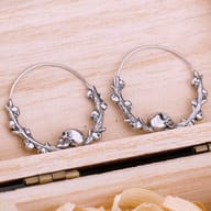 Gothic skull hoop earring worn on an ear showing scale and style