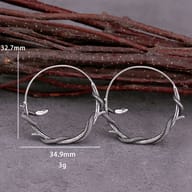 Top-down view of the snake hoop earrings displaying clasp closure and oxidized finish