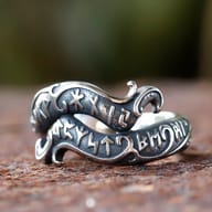 Angled shot of the durable 316L stainless steel rune ring, emphasizing its metallic luster and intricate design.