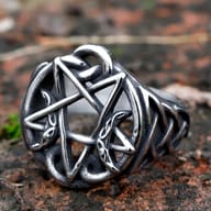Stainless Steel Celtic Knot Pentagram Ring on a natural, textured surface.