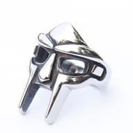 Dynamic shot of the stainless steel MF Doom ring, capturing its hip hop and punk aesthetic.