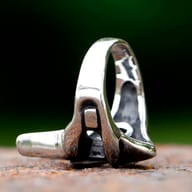 Angled view of the unique men's stainless steel ring, showcasing the iconic mask motif.